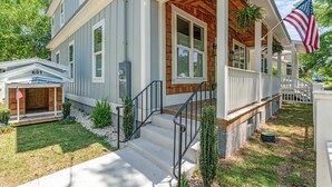 A two-story house with a porch, a front entrance, and a mailbox.