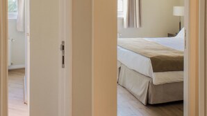 A hotel room with a bed, a nightstand, and a window with curtains. - Charming 2-bedroom apartment in beautiful Lastarria Santiago with AC, WiFi (Santiago)