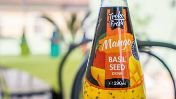 A bottle of Troke Fresh Mango Basil Seed Drink on a table.