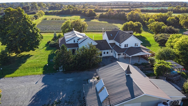 A large house with a spacious driveway and a well-maintained lawn.