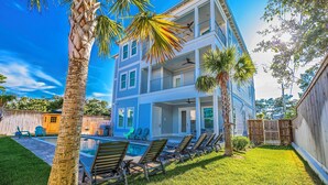 A multi-story building with a pool, outdoor seating, and a fenced backyard. - Blue Horizon • Golf Cart, Pool & Sleeps 32 (Santa Rosa Beach)