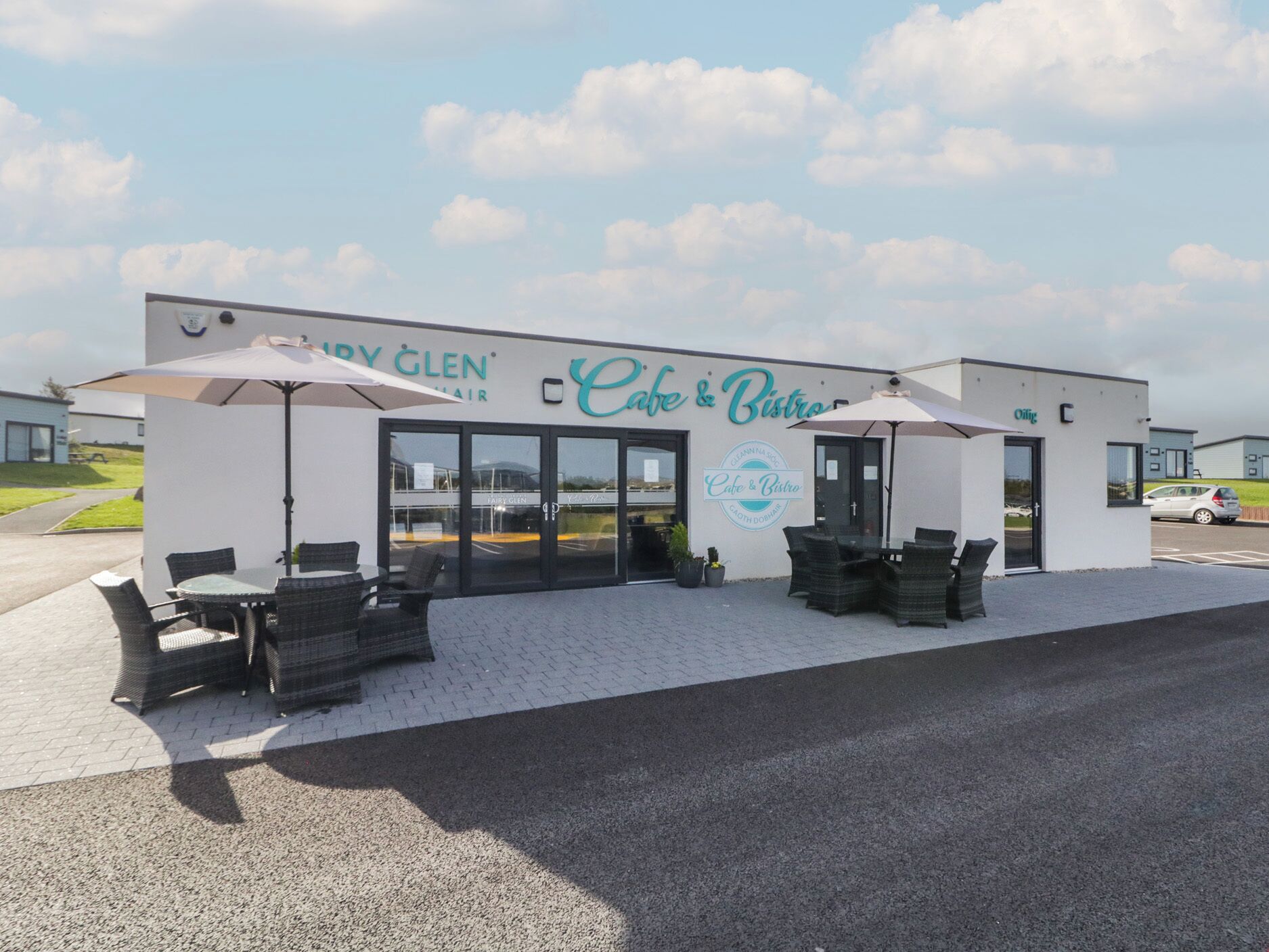A cafe and bistro with outdoor seating and a clear sky.