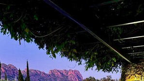 A patio with stone flooring, outdoor seating, a barbecue grill, and a view of mountains. - Villa Rocks 3120 - A haven of peace at the foot of Roquebrune rock (Roquebrune-sur-Argens)