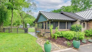 A house with a covered porch, stone exterior, and a well-maintained lawn. - Boutique-Style Barn Stay 4 Mi to Franklin Main St (Franklin)
