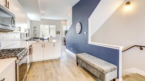 A modern kitchen with white cabinetry, a built-in oven, and a gas stove. - 2 Mi to Ball Arena: Townhome w/ Rooftop Patio (Denver)