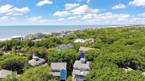 A residential area with houses surrounded by trees and a beach in the background. - Steps to Beach & Pool Screened Porch Pelican Bay 45 at Wild Dunes Resort (Isle of Palms)