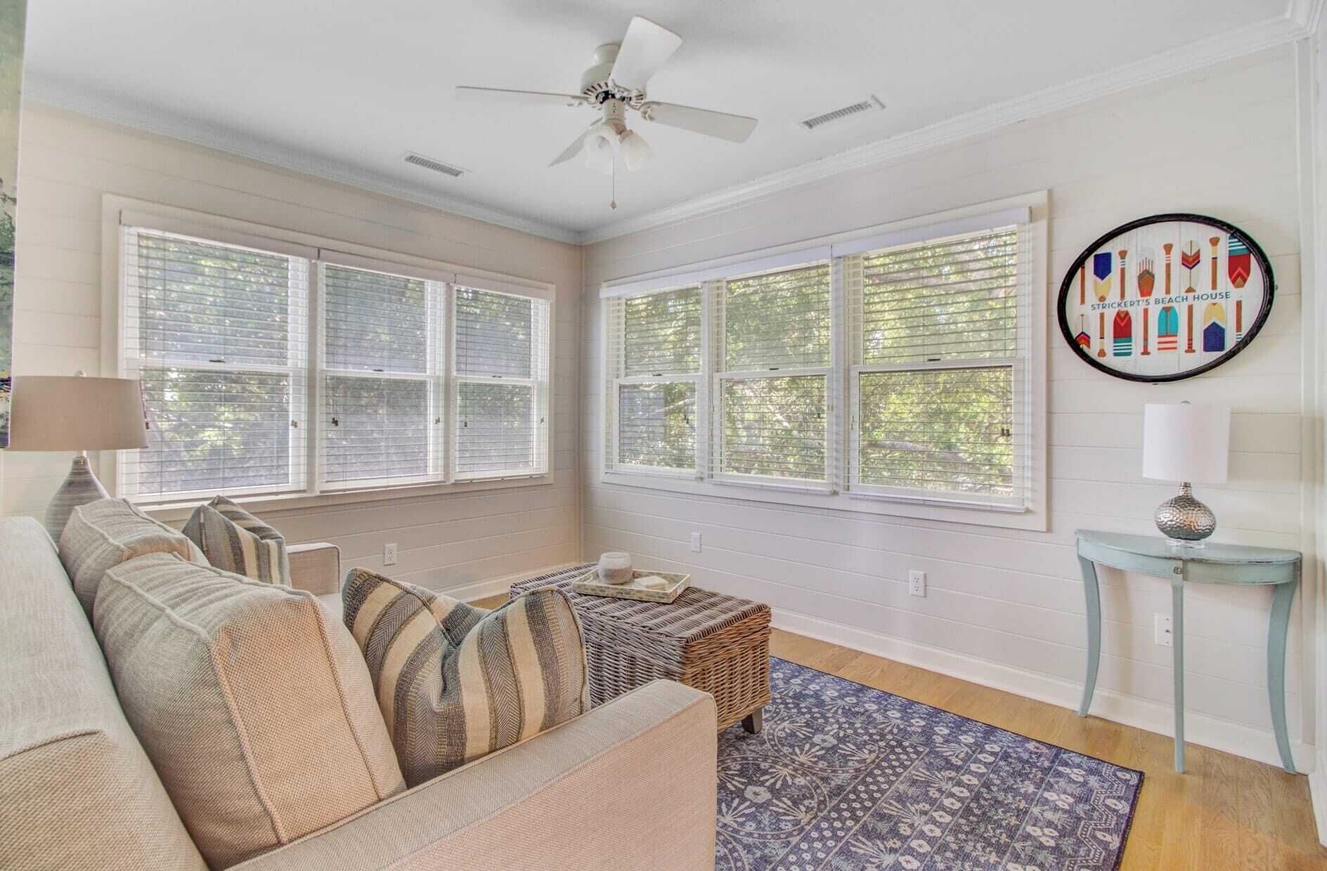 A cozy living room with a sofa, a small side table, and a decorative wall piece.