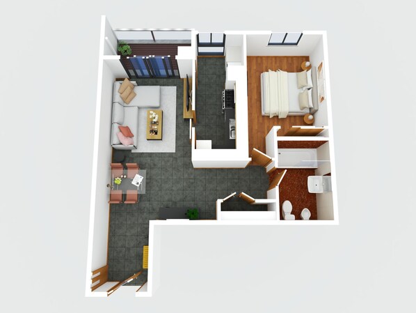 Un appartement de deux chambres comprenant un salon, un coin repas, une cuisine et un balcon.