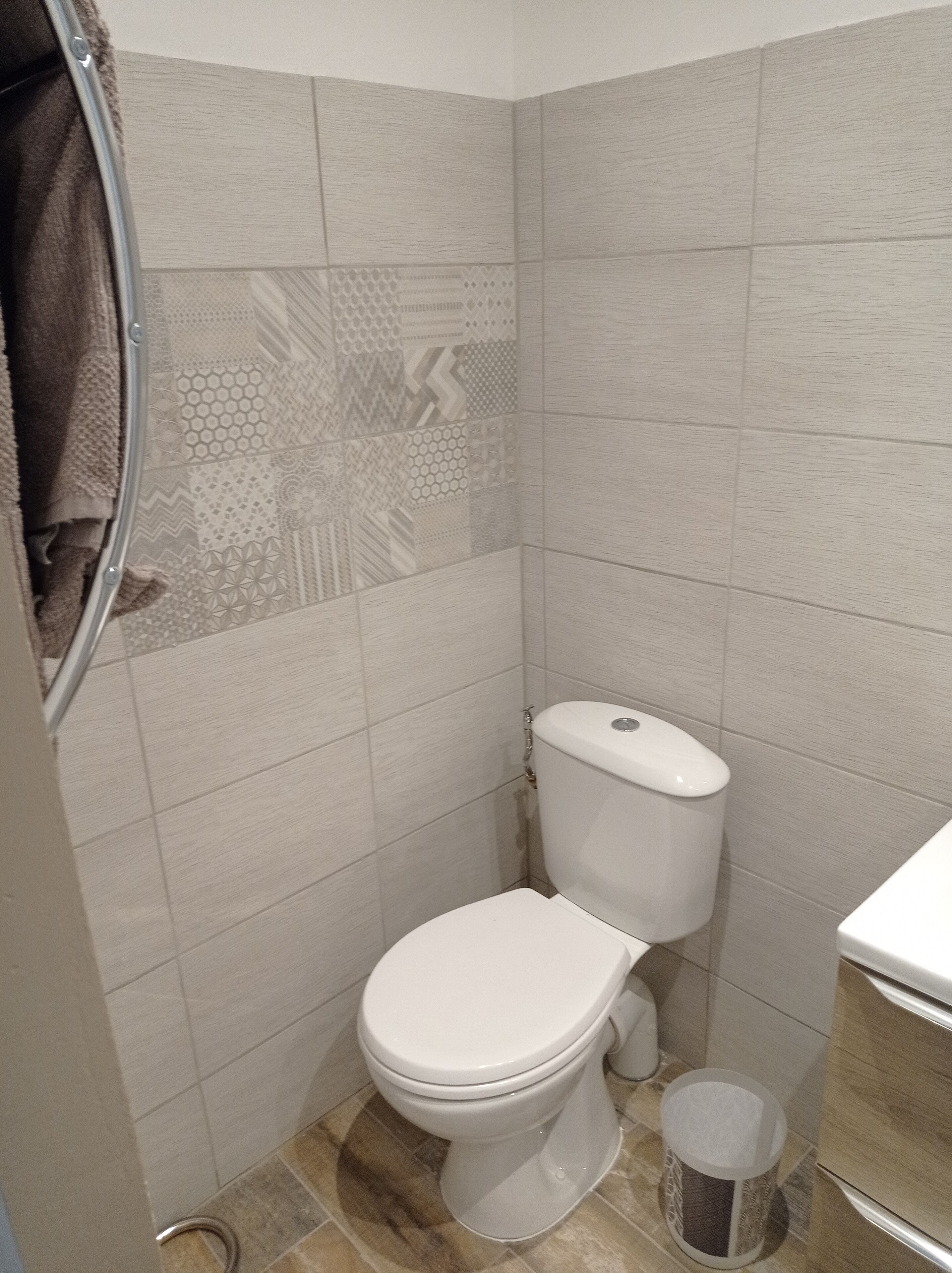 Un bagno con il water, un bidet e un cestino.