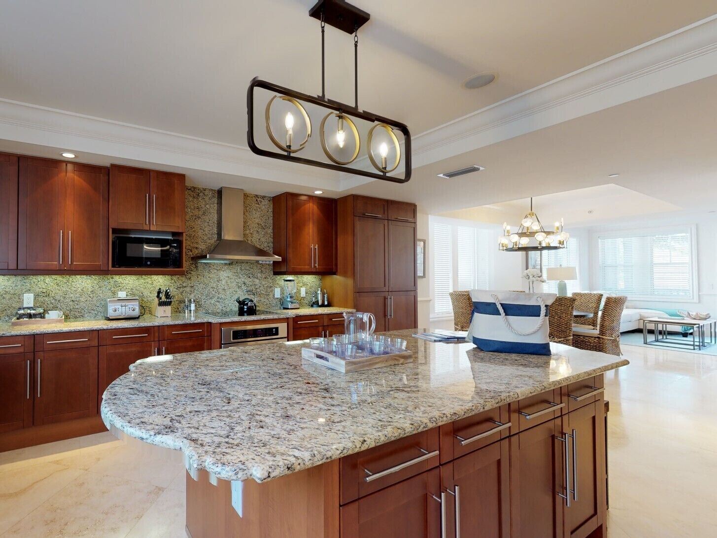 A modern kitchen with granite countertops, wooden cabinets, and a central island.