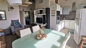 A modern kitchen with white cabinets, a built-in oven, and a microwave. - Villa 54 at Colibri d'Isa, a haven of peace between sea, mountains and rainforest (CAPESTERRE BELLE EAU)