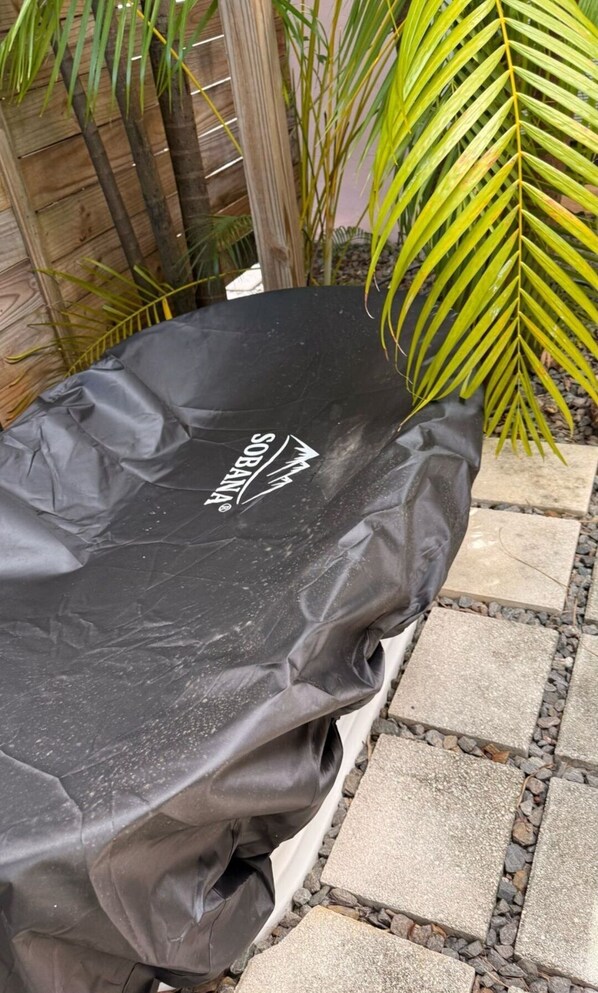 A covered outdoor grill with the brand name 'SOBANA' visible on the cover.
