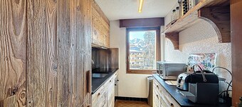 A living room with fireplace, a kitchen, a Nespresso coffee machine and dishwasher, 1 bedroom with 2