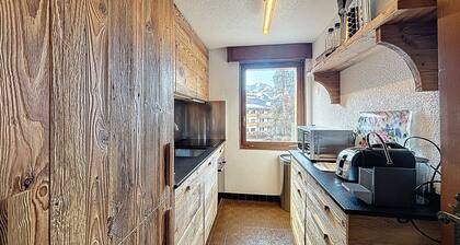 A living room with fireplace, a kitchen, a Nespresso coffee machine and dishwasher, 1 bedroom with 2