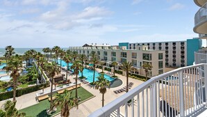 A hotel with a pool area, palm trees, and a view of the ocean. - Sapphire Condominiums 406 - 3 bedroom, 2 bath, ***All reservations require a 72 hour notice*** (South Padre Island)
