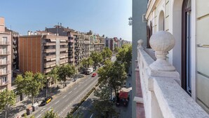A city street with buildings, trees, and a clear sky.