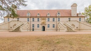 A large, historic building with a symmetrical facade, two grand staircases, and a central entrance. - La Maison de Marius - SAINT BONNET DE JOUX (SAINT BONNET DE JOUX)