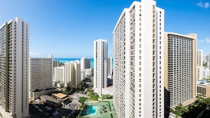 Un grand hôtel à plusieurs étages, doté d’une piscine et offrant une vue sur l’océan.