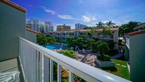 A hotel with a pool, multiple buildings, and a clear sky. - Beachside Rental w/ Balcony & Pool (Boca Raton)