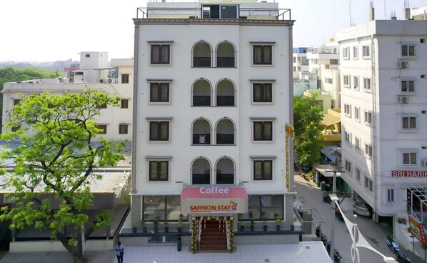 A multi-story building with a coffee shop on the ground floor.