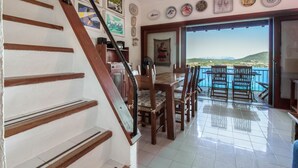 A staircase leading to a balcony with a view of the sea. - GuestHost - Dreamy Sea View with Pool and Parking (Olbia)