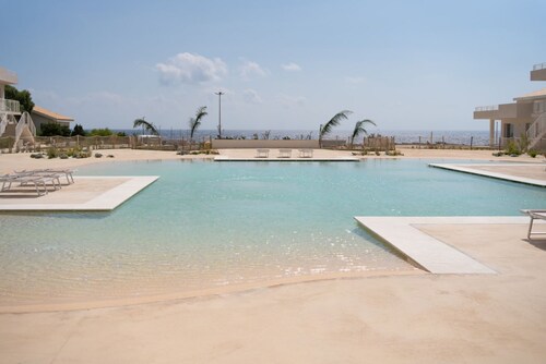 GuestHost - Charming 40 sqm seaview flat, able to accommodate up to 3 people, located inside the renowned Borgo 84 residence, equipped with swimming pool and cycle path. The property is located just 3 km from the center of Marzamemi, one of the most fasc