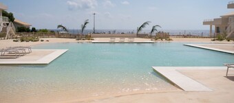 GuestHost - Charming 40 sqm seaview flat, able to accommodate up to 3 people, located inside the renowned Borgo 84 residence, equipped with swimming pool and cycle path. The property is located just 3 km from the center of Marzamemi, one of the most fasc