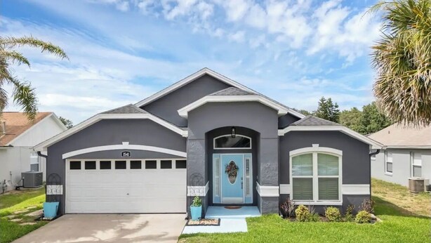 A single-story house with a garage, a front porch, and a well-maintained lawn.