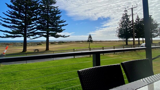 A balcony with a view of a grassy field, trees, and a clear sky. - BIG4 Kingston Foreshore Holiday Park (Kingston SE)