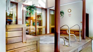 A wooden deck with a hot tub, metal railings, and glass doors with plants. - Cozy 1BR Condo w/ Pool Access in Vail (Vail)