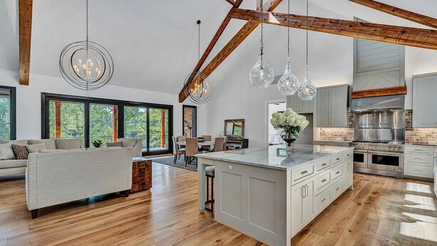 A spacious living area with a large island, wooden beams, and a modern kitchen with stainless steel appliances. - Private Dock, 30 day rentals (Union Hall)