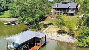 A lakeside cabin with a dock, surrounded by dense forest. - Private Dock, 30 day rentals (Union Hall)