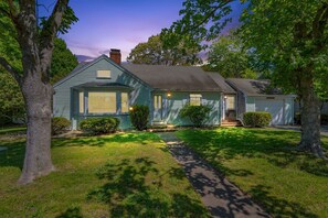 A single-story house with a front porch, a garage, and a well-maintained lawn. - Family & Pet-Friendly Cape Escape Near Beach (Hyannis)