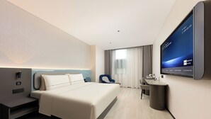A modern hotel room with a large bed, a desk, a chair, and a TV mounted on the wall. - Atour Light Shanghai Pudong Airport Shixin Road Hotel (Shanghai)
