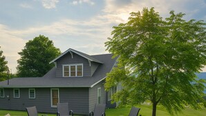 A house with a patio area featuring a fire pit and outdoor seating.