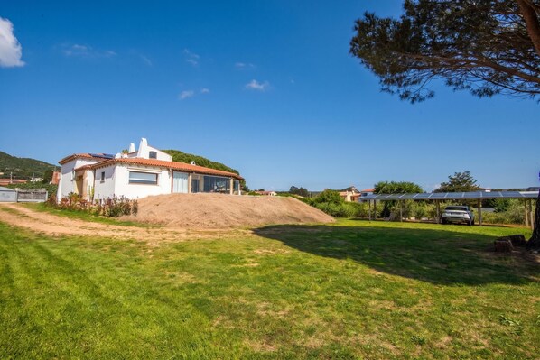 A house with a sloped roof, a garage, and a solar panel array.