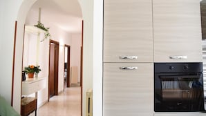 A modern kitchen with a built-in oven and a hallway leading to a room with a plant. - Apartment 'Katospedi House' with Balcony, Wi-Fi and Air Conditioning (Lecce)