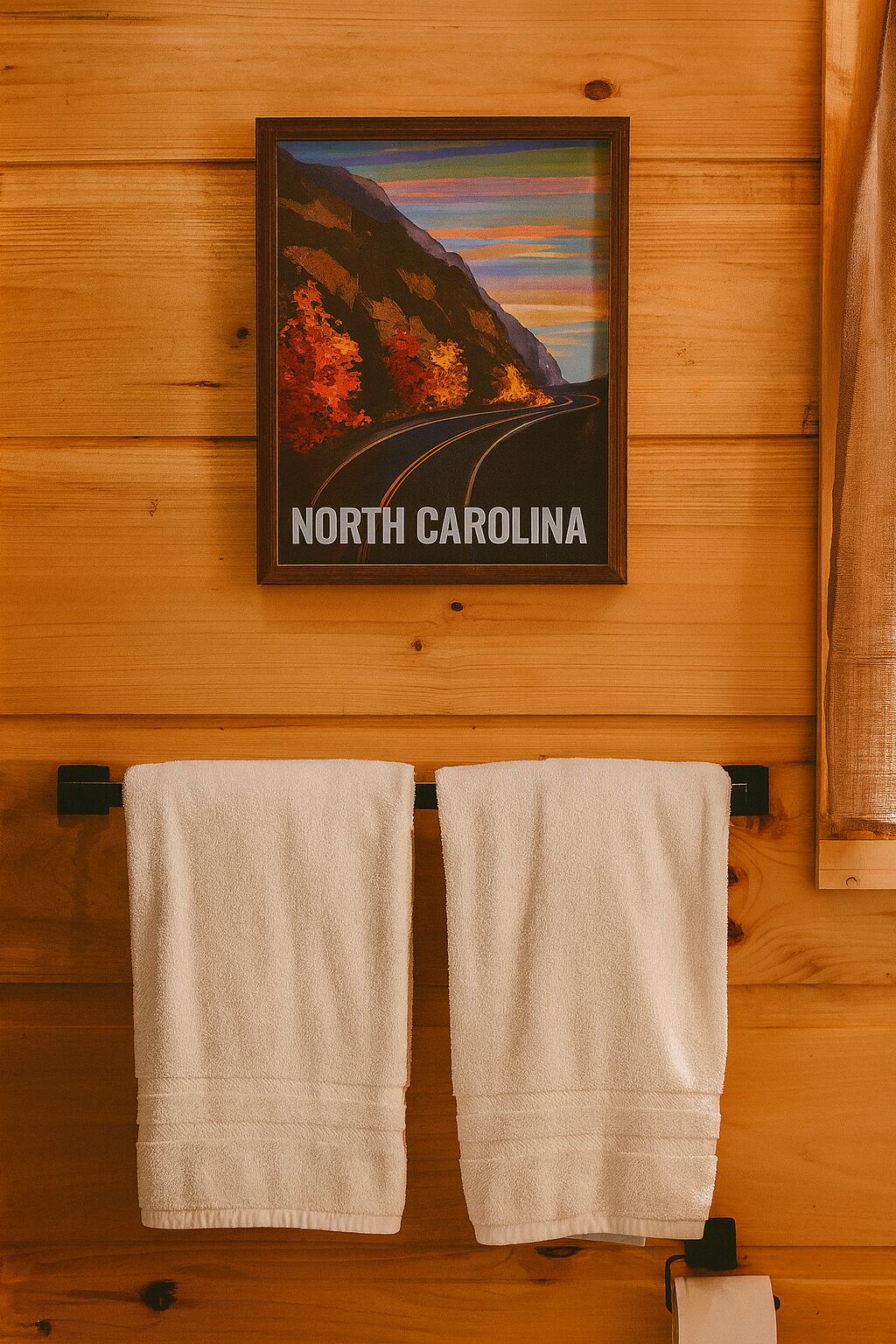 A framed picture of a road with the text "North Carolina" on a wooden wall.