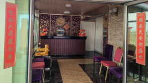 A reception area with a wooden ceiling, a reception desk, and chairs. - Lata Hotel (Nuku'alofa)