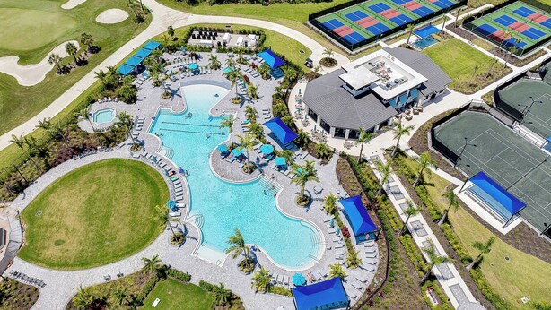 An aerial view of a resort with a large central pool, tennis courts, and a covered pavilion. - WELLEN GOLF & COUNTRY CLUB GATAWAY 
In a Modern Style 2 bd Condo (Venice)