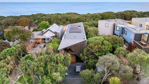 A modern residential area with multiple houses, including a prominent house with a sloped roof and solar panels. - Aireys Cliff-Top Gem - Your Ultimate Coastal Escape (Aireys Inlet)