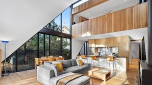 A modern loft-style apartment with a large living area, a kitchen, and a dining space. - Aireys Cliff-Top Gem - Your Ultimate Coastal Escape (Aireys Inlet)
