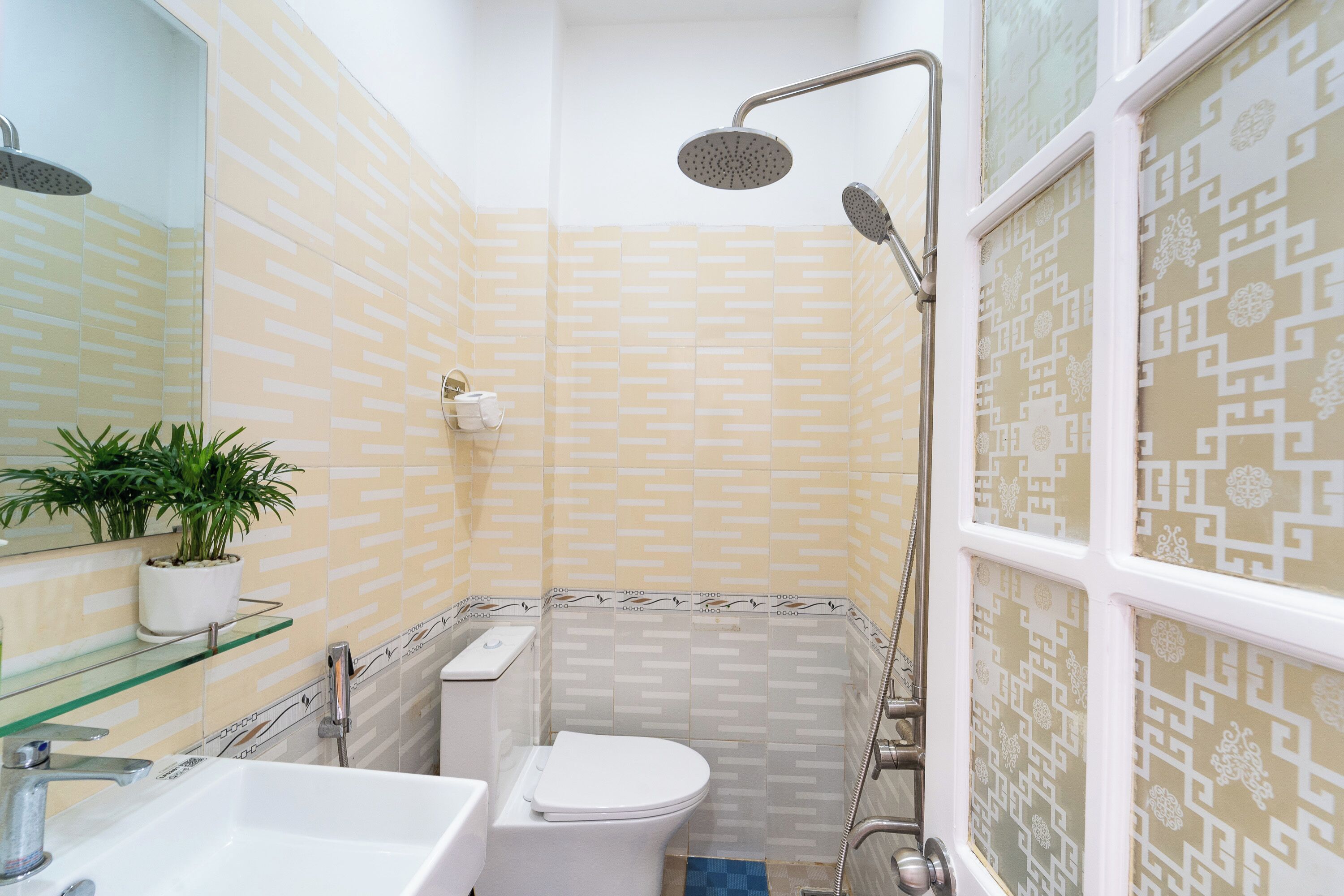 A bathroom with a toilet, sink, and shower.