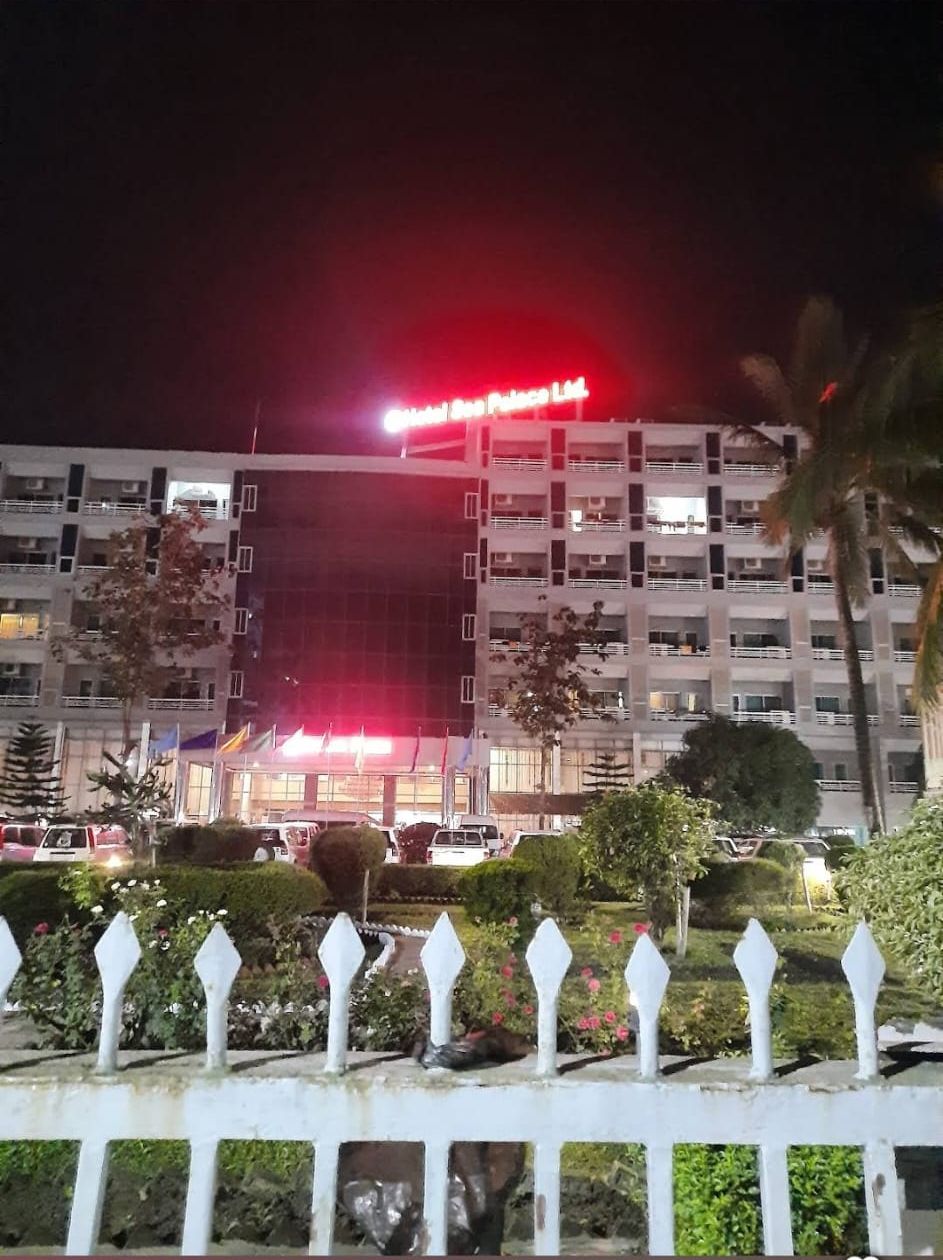 Un edificio de varios pisos con un letrero rojo que indica un hotel.