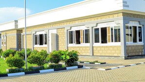 A building with a beige facade, large windows, and a brick base. - country sights Hotel Bulisa (Bulisa)