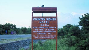 A sign for Country Sights Hotel in Bulisa, featuring contact information and a website. - country sights Hotel Bulisa (Bulisa)