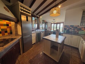 Enjoy cooking in this well-equipped kitchen with a large island, oven, and ample workspace.