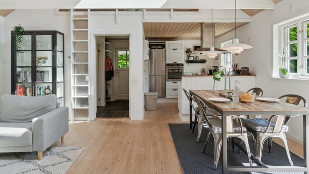 A spacious living area with a high ceiling, wooden beams, a dining table with chairs, a kitchen with modern appliances, and a bookshelf. - "Veljan" - 1.2km from the sea by Interhome (Vig)