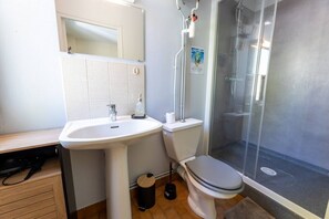 A bathroom with a sink, toilet, and shower.