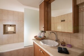 A bathroom with a sink, mirror, and towel rack. - Posto Serene With Jacuzzi (Minoa Pediada)